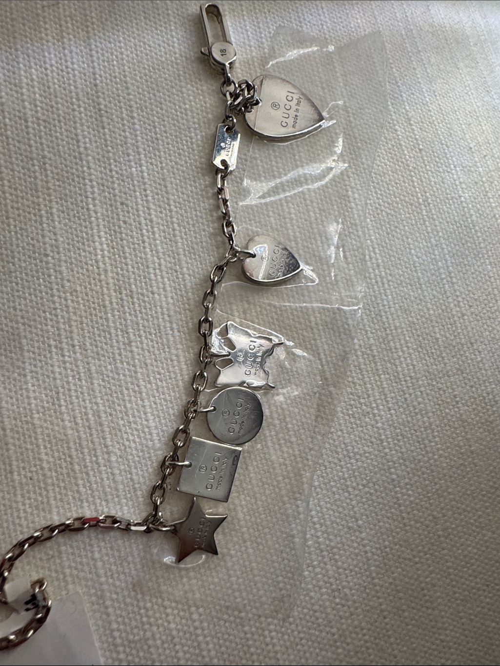 Gucci Silver-Tone Charm Bracelet With Assorted Logo Charms